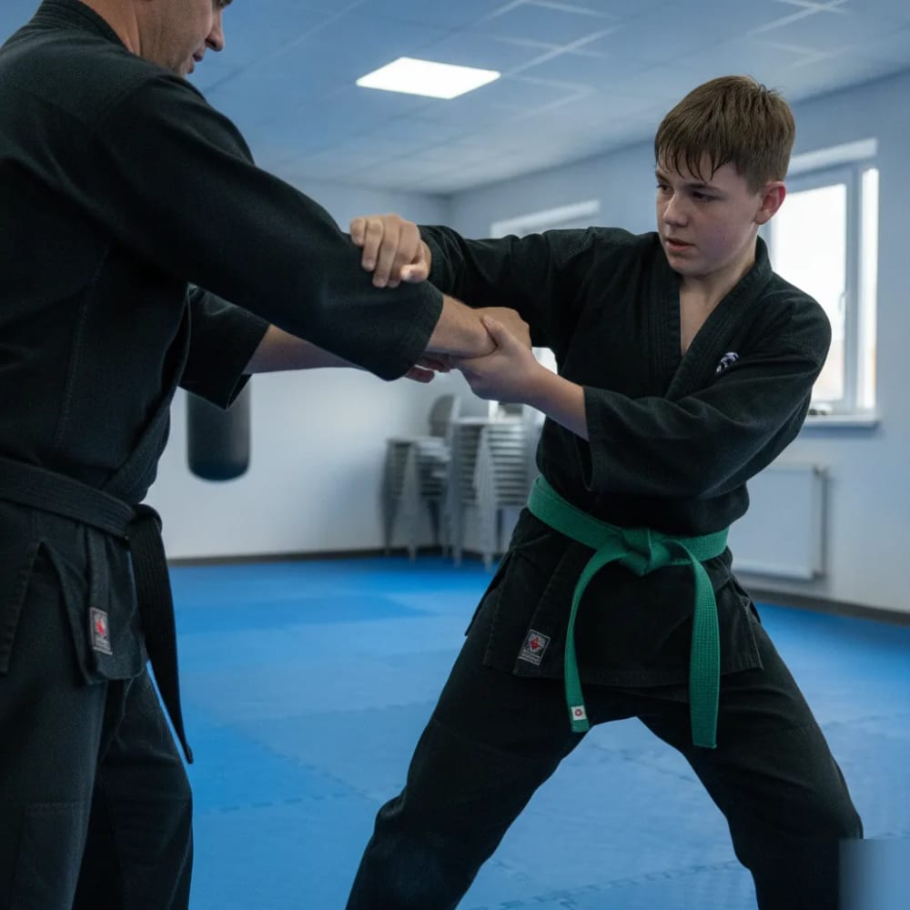Teen student practicing a Kosho-Ryu joint-lock escape with his instructor at James Martial Arts Academy in El Cajon