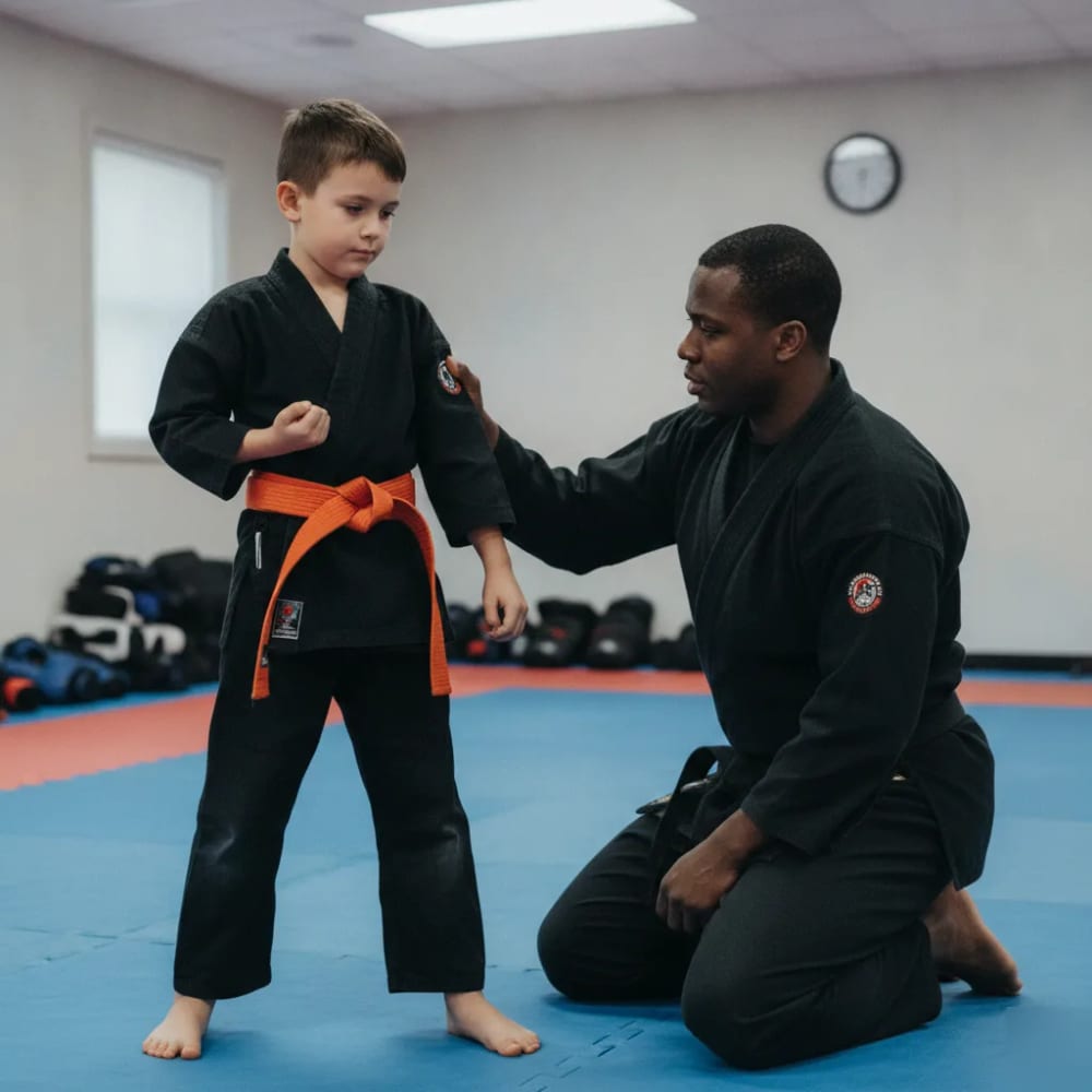 Instructor guiding a boy through a modified martial arts stance for special needs in El Cajon