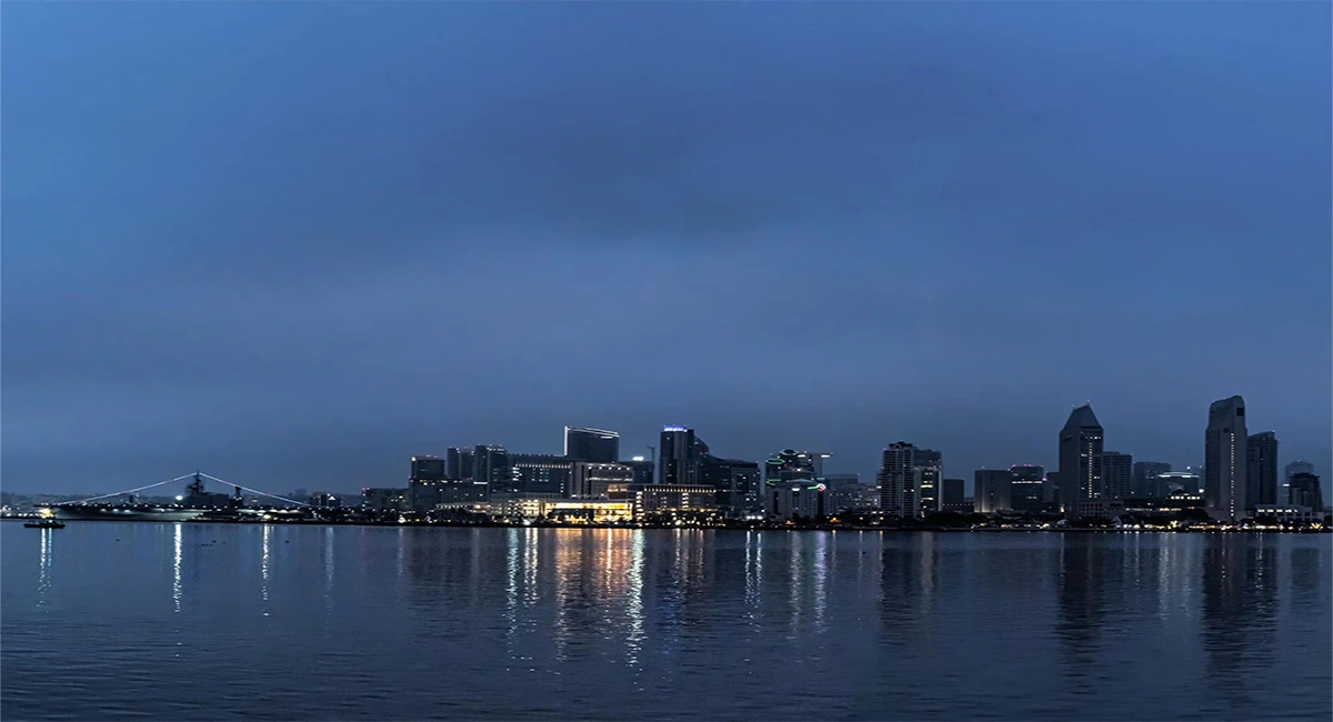 Downtown San Diego skyline at blue hour with the USS Midway and the city lights reflected on the bay — the broader San Diego region served by James Martial Arts Academy from East County El Cajon